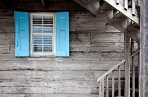 a wooden house with blue shutters