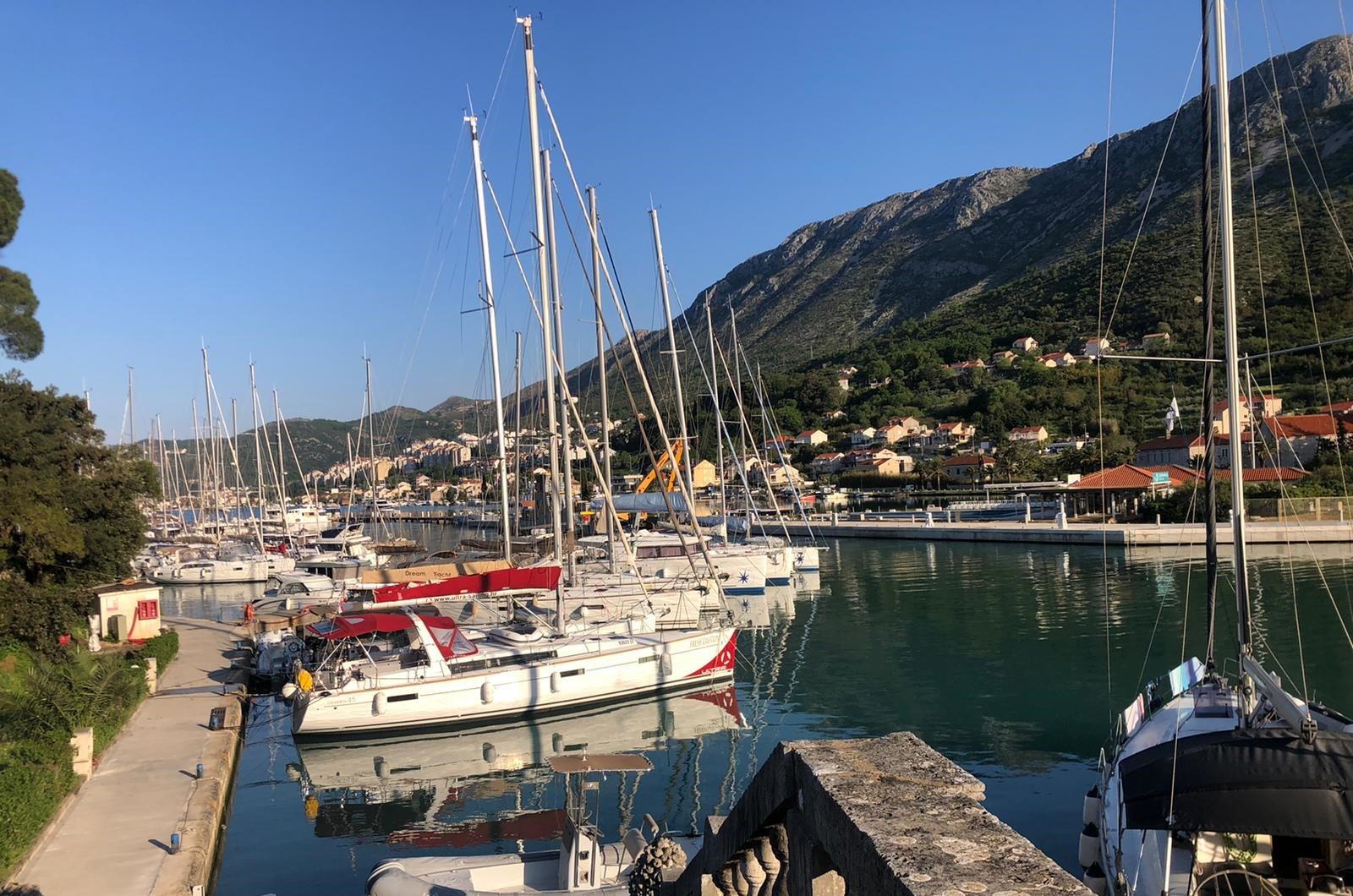 a view across a harbour full of sailing boats